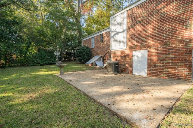 view of yard featuring central AC and a patio