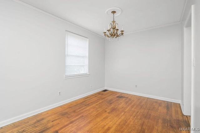 3712 Ware Ct, Montgomery, AL 36109 - unfurnished room featuring visible vents, wood finished floors, baseboards, a chandelier, and ornamental molding