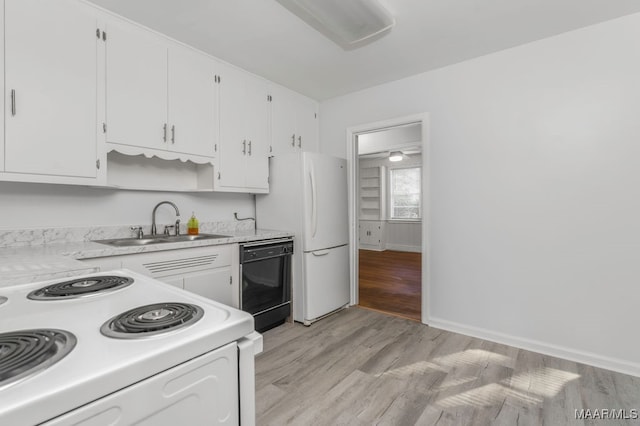 kitchen with white appliances, light hardwood / wood-style flooring, sink, and white cabinets