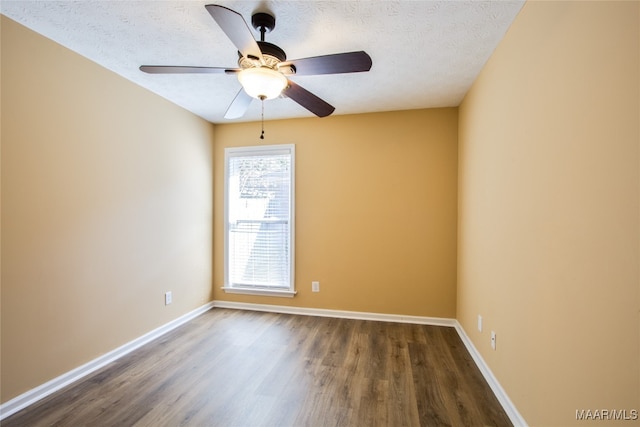 unfurnished room with dark wood-type flooring, a textured ceiling, and ceiling fan