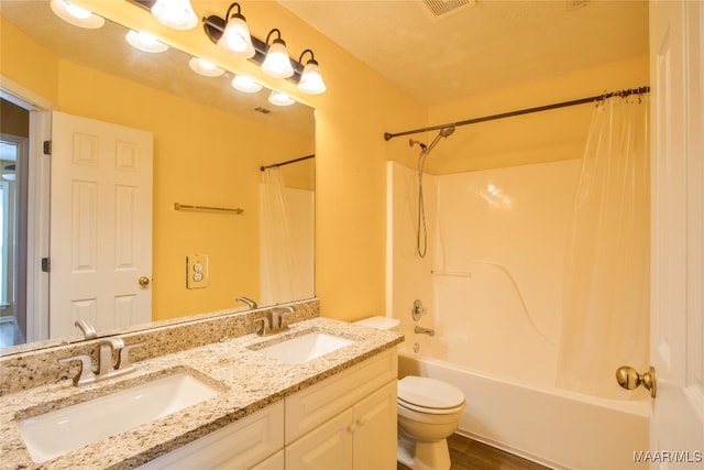 full bathroom with toilet, shower / bath combination with curtain, wood-type flooring, vanity, and a textured ceiling