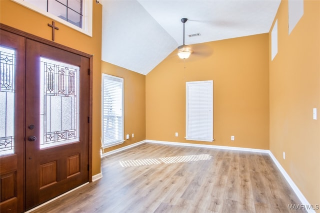 foyer featuring high vaulted ceiling, light wood-type flooring, and ceiling fan