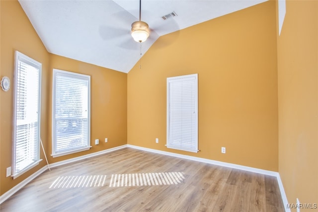 unfurnished room with light hardwood / wood-style flooring, ceiling fan, and vaulted ceiling