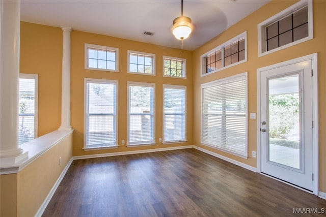 entryway with ornate columns, dark hardwood / wood-style floors, and ceiling fan