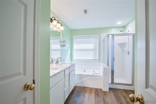 bathroom featuring vanity, hardwood / wood-style floors, and separate shower and tub