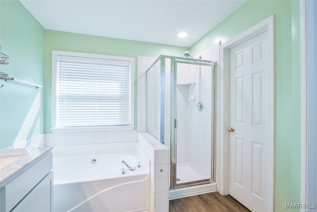 bathroom with vanity, shower with separate bathtub, and wood-type flooring