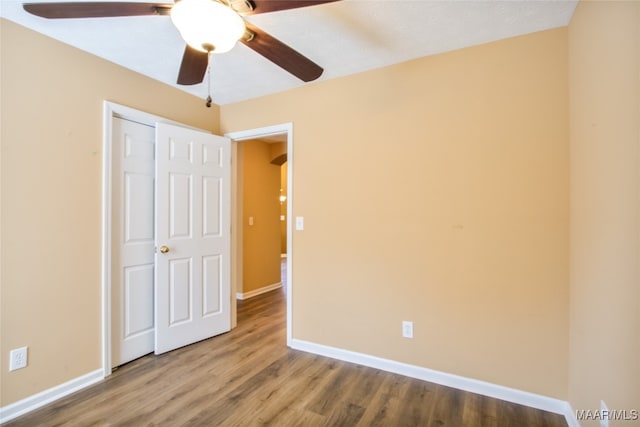 unfurnished bedroom featuring a closet, ceiling fan, and hardwood / wood-style floors