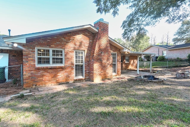 back of house featuring a yard