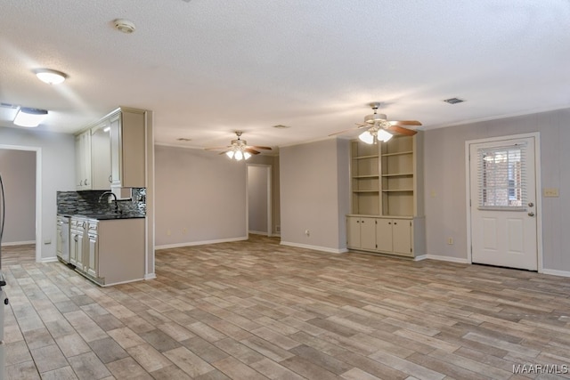 kitchen featuring backsplash, a textured ceiling, light hardwood / wood-style floors, and ceiling fan