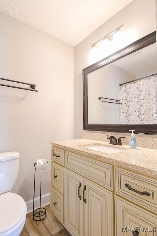 bathroom with vanity, toilet, wood-type flooring, and a shower with shower curtain