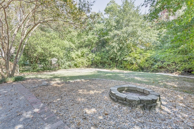 view of yard featuring an outdoor fire pit