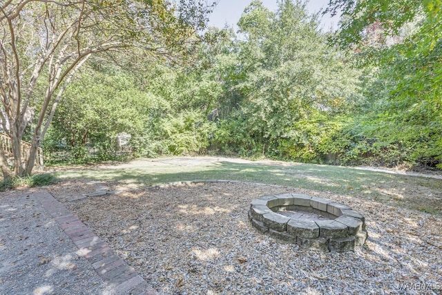 view of yard with a fire pit