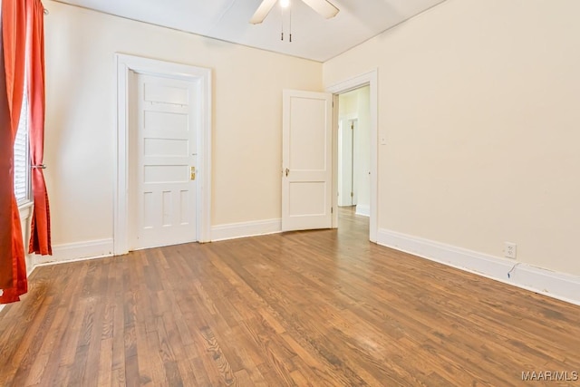 empty room with baseboards, a ceiling fan, and wood finished floors