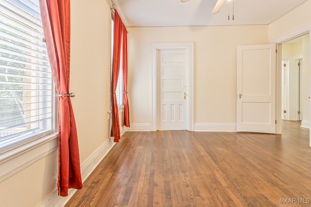 interior space with dark wood-type flooring and ceiling fan