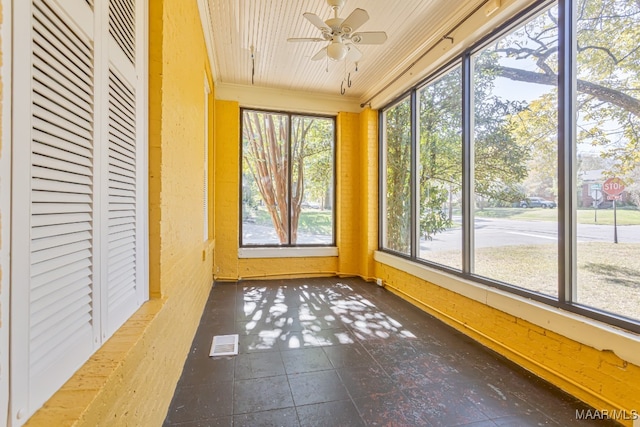 unfurnished sunroom with ceiling fan and a wealth of natural light