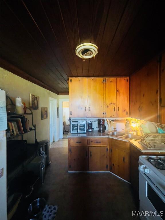 895 Lamar Rd, Hope Hull, AL 36043 - kitchen featuring wood ceiling, white gas range, a sink, brown cabinets, and light countertops