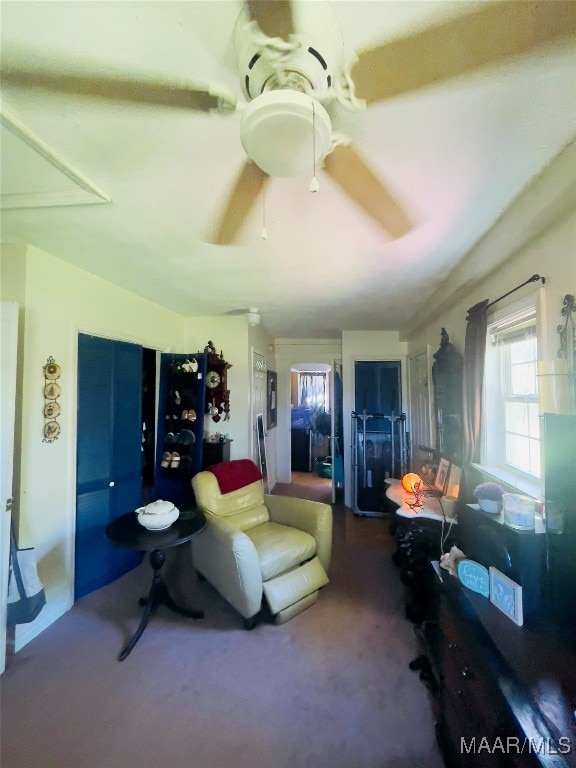 carpeted living room featuring ceiling fan