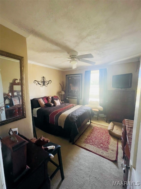 bedroom with ornamental molding, carpet, and ceiling fan