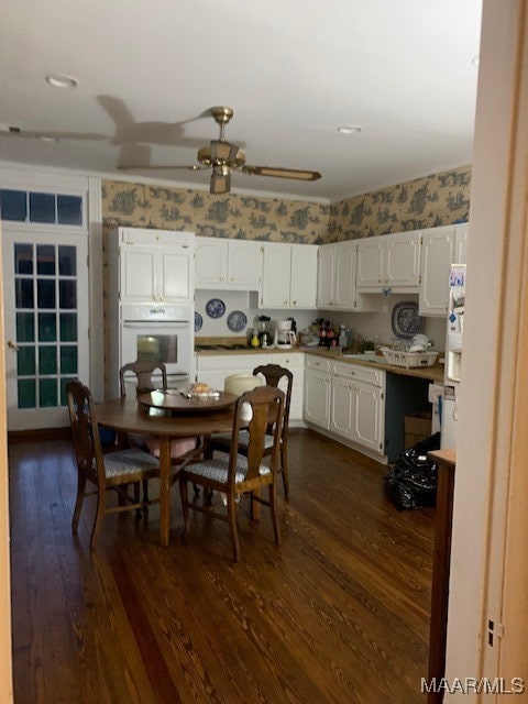 dining area featuring dark hardwood / wood-style floors and ceiling fan