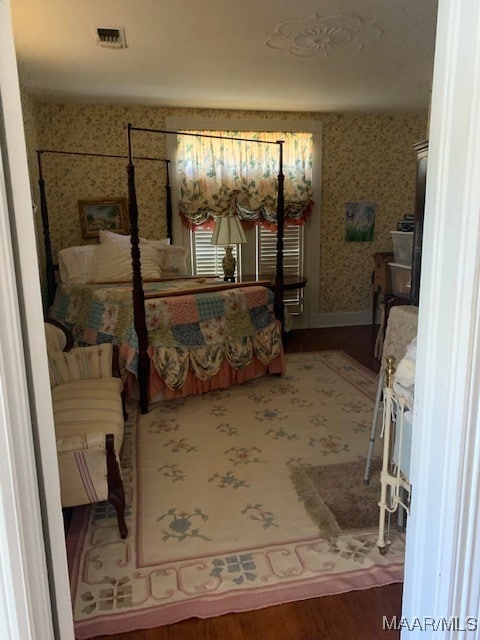 bedroom with hardwood / wood-style flooring