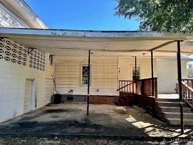 view of side of home with a carport