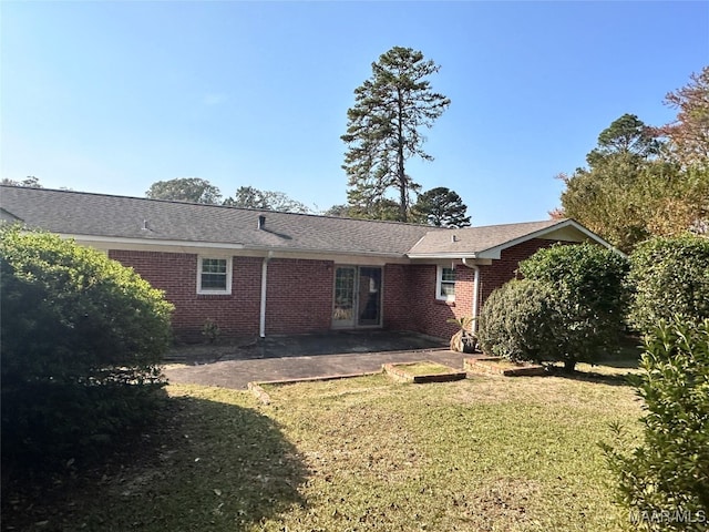 back of property featuring a yard and a patio area