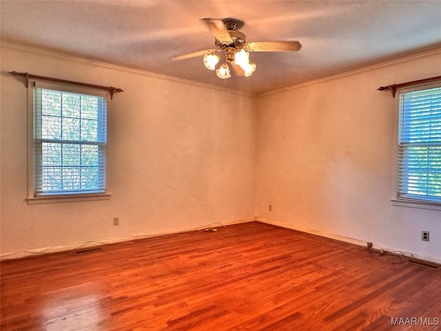 unfurnished room featuring crown molding, wood-type flooring, and ceiling fan