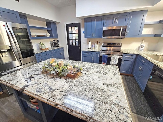 kitchen with appliances with stainless steel finishes, blue cabinetry, and open shelves