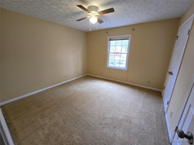 unfurnished bedroom with carpet floors, ceiling fan, baseboards, and a textured ceiling