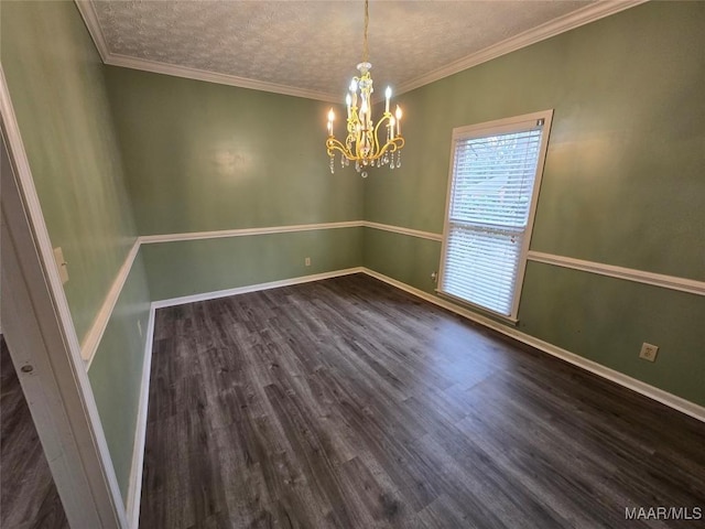 unfurnished room featuring a chandelier, ornamental molding, dark wood-style flooring, and baseboards