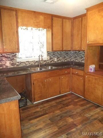 kitchen with a sink, tasteful backsplash, and brown cabinetry