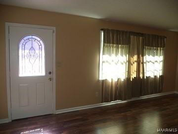 foyer entrance with wood finished floors and baseboards