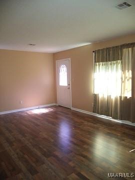 entryway with baseboards and dark wood-style floors