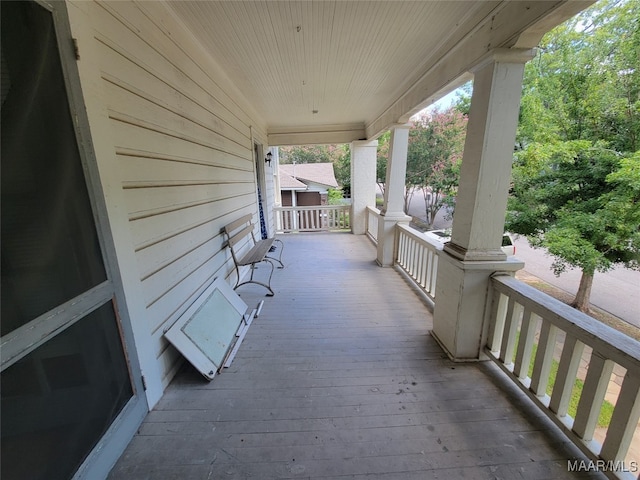 wooden terrace featuring covered porch