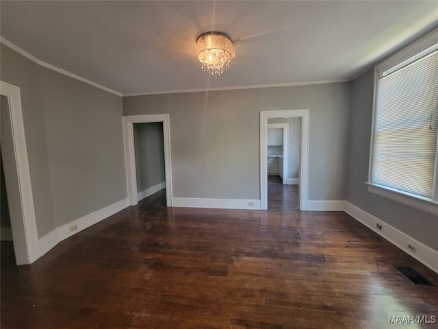 unfurnished room featuring ornamental molding and dark wood-type flooring