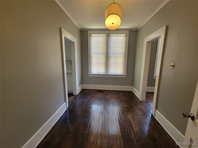 unfurnished dining area featuring ornamental molding and dark wood-type flooring