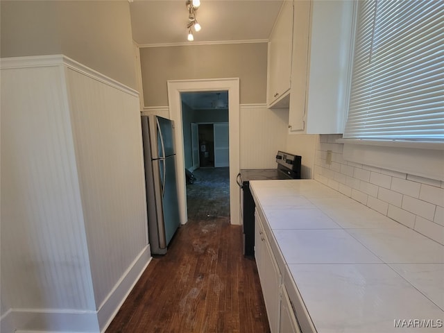 kitchen with dark hardwood / wood-style floors, tile counters, black electric range, white cabinetry, and stainless steel refrigerator