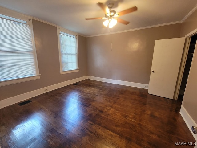 unfurnished room featuring dark hardwood / wood-style flooring, ornamental molding, and ceiling fan