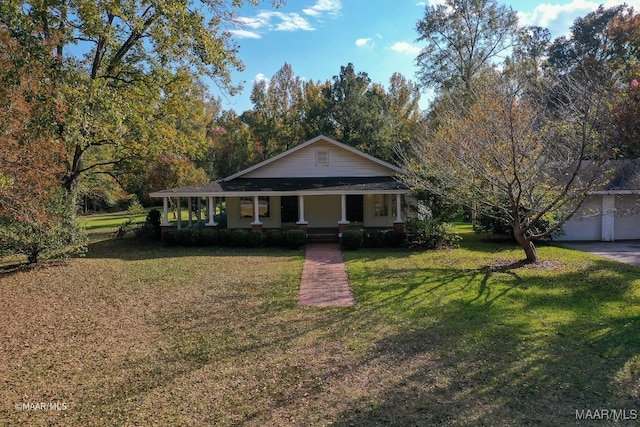 view of front facade with a front yard, a porch, and a garage