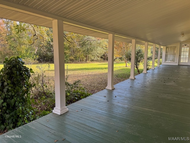 wooden terrace with a lawn