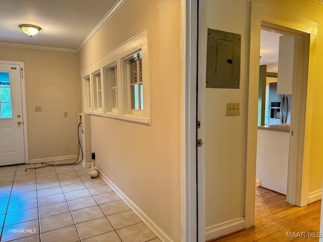 interior space featuring light tile patterned floors, crown molding, and electric panel