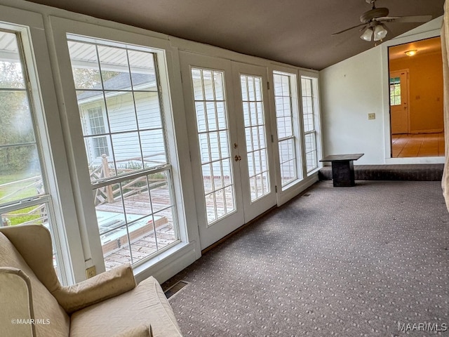 doorway with ceiling fan, carpet floors, and french doors