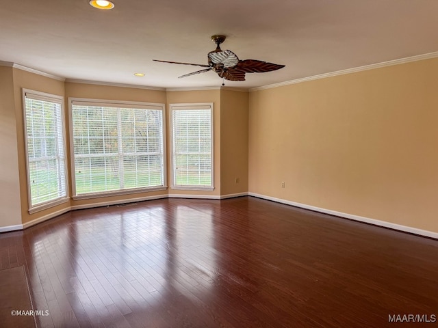 spare room with ornamental molding, ceiling fan, and dark wood-type flooring