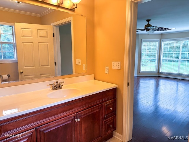 bathroom with a wealth of natural light, hardwood / wood-style floors, ceiling fan, and crown molding