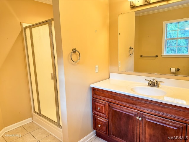 bathroom with tile patterned floors, vanity, ornamental molding, and walk in shower