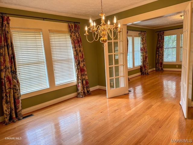 unfurnished dining area featuring a wealth of natural light, hardwood / wood-style floors, and crown molding