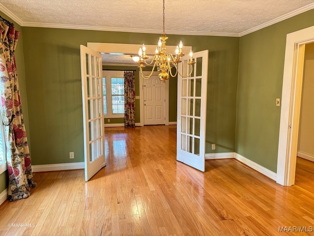 unfurnished dining area with hardwood / wood-style floors and french doors