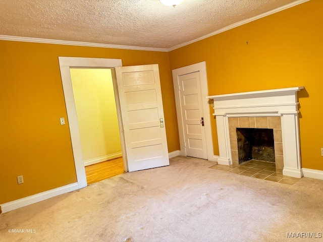 unfurnished living room featuring carpet, a textured ceiling, a tile fireplace, and ornamental molding