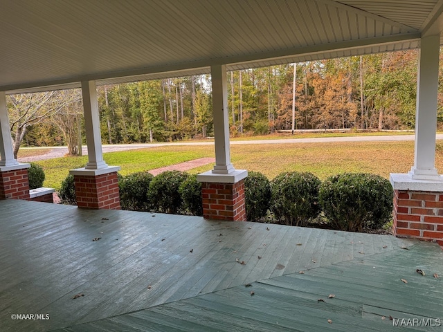 wooden deck with a lawn