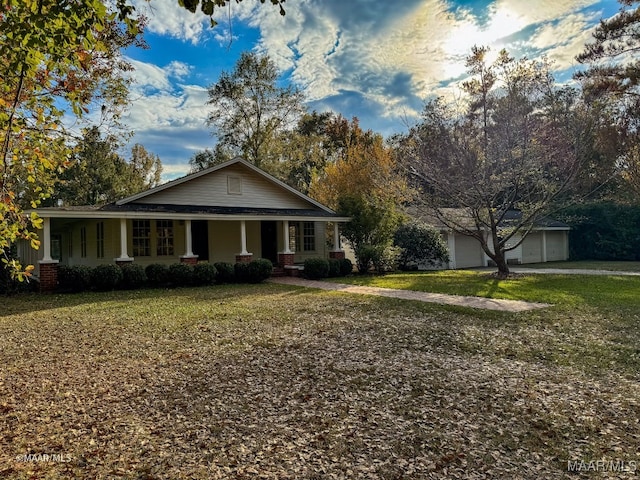 view of front of home featuring a front lawn, an outdoor structure, and a garage